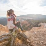Connected hands holding a smartphone displaying the text 'Call my wife from US traveling in Italy'