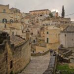 Men Italy Travel Winter MEN ITALY TRAVEL WINTER: Group of men exploring the snow-covered landscapes of Italy during winter