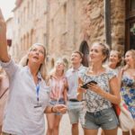 Group of travelers exploring ancient ruins on adventure travel tours Italy
