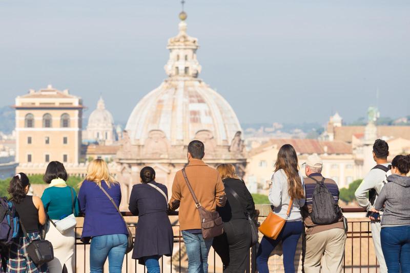 Tourists in a group exploring Italy's attractions independently, enjoying their trip in January