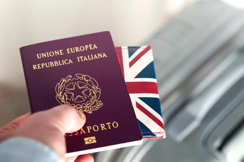 Passport being checked while traveling from Italy to Switzerland by train